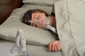 woman sleeping with CPAP machine 300x199 - 3 Common CPAP Problems and How to Solve Them